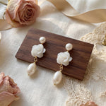 Pair of pearl flower dangle earrings styled with roses ribbon and lace
