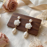 Pair of pearl flower dangle earrings styled with roses ribbon and lace