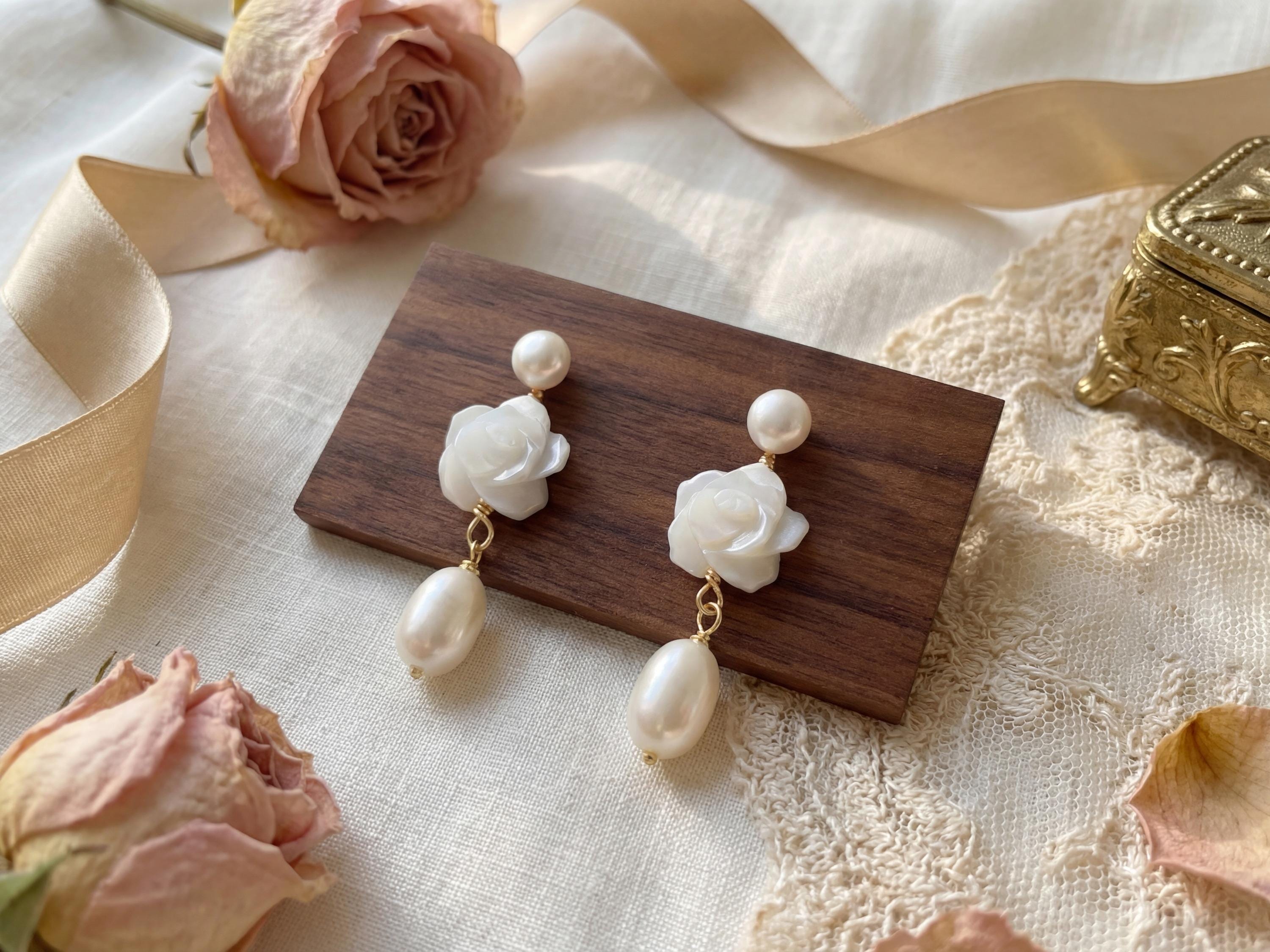 Pair of pearl flower dangle earrings styled with roses ribbon and lace