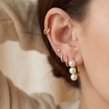 Triple pearl leverback earring styled with a minimalist gold ear stack