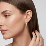 Model wearing compact three pearl leverback earrings with a polished bridal look