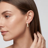 Model wearing compact three pearl leverback earrings with a polished bridal look