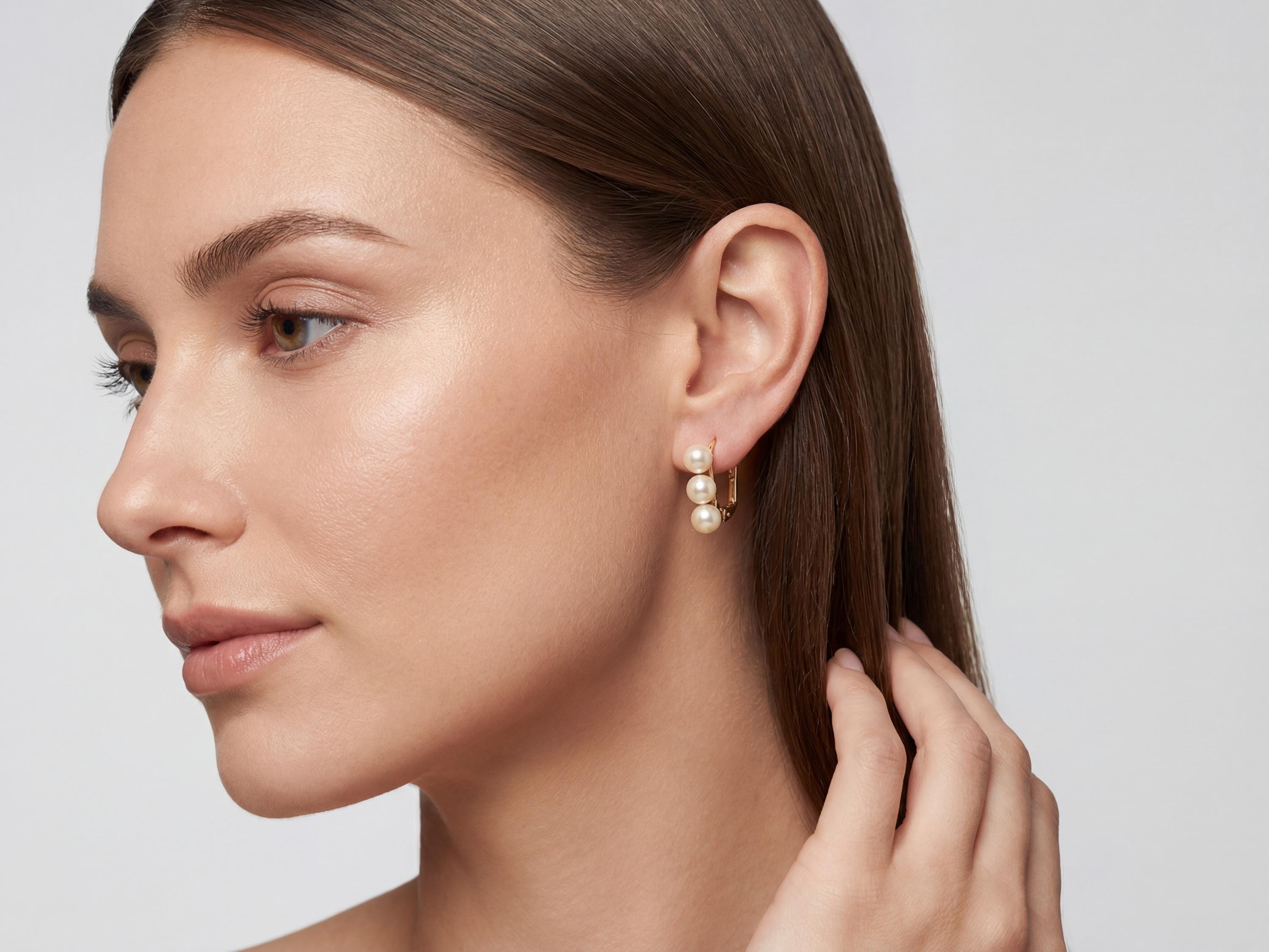 Model wearing compact three pearl leverback earrings with a polished bridal look