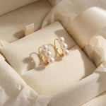 Triple freshwater pearl earrings presented in a cream gift box with ribbon