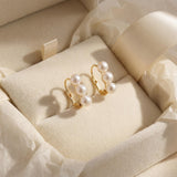 Triple freshwater pearl earrings presented in a cream gift box with ribbon