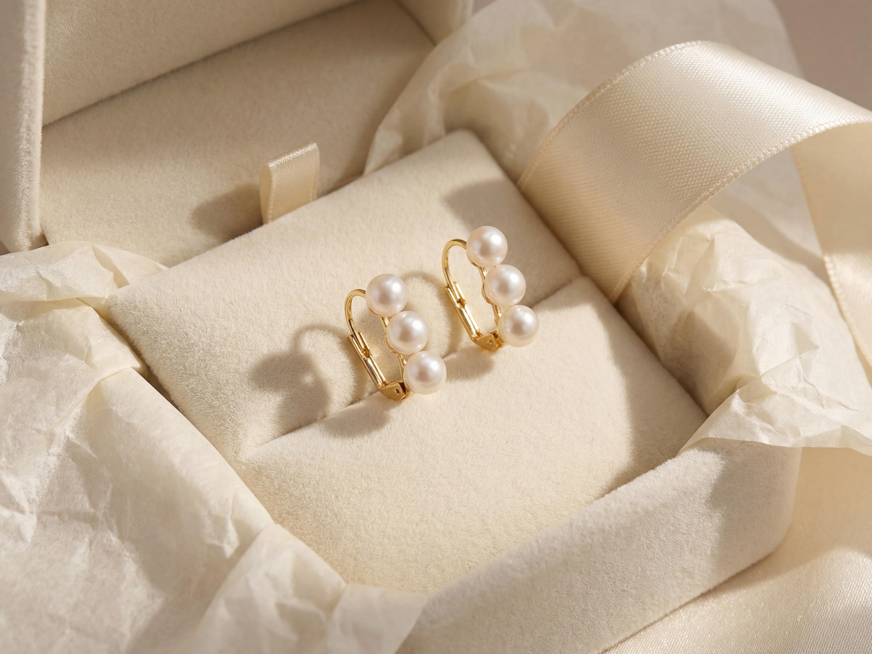 Triple freshwater pearl earrings presented in a cream gift box with ribbon
