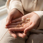 Pearl earrings listing image - Editorial hands shot