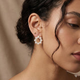 Freshwater pearl cluster stud earrings worn on ear, showing the circular wreath shape and everyday scale