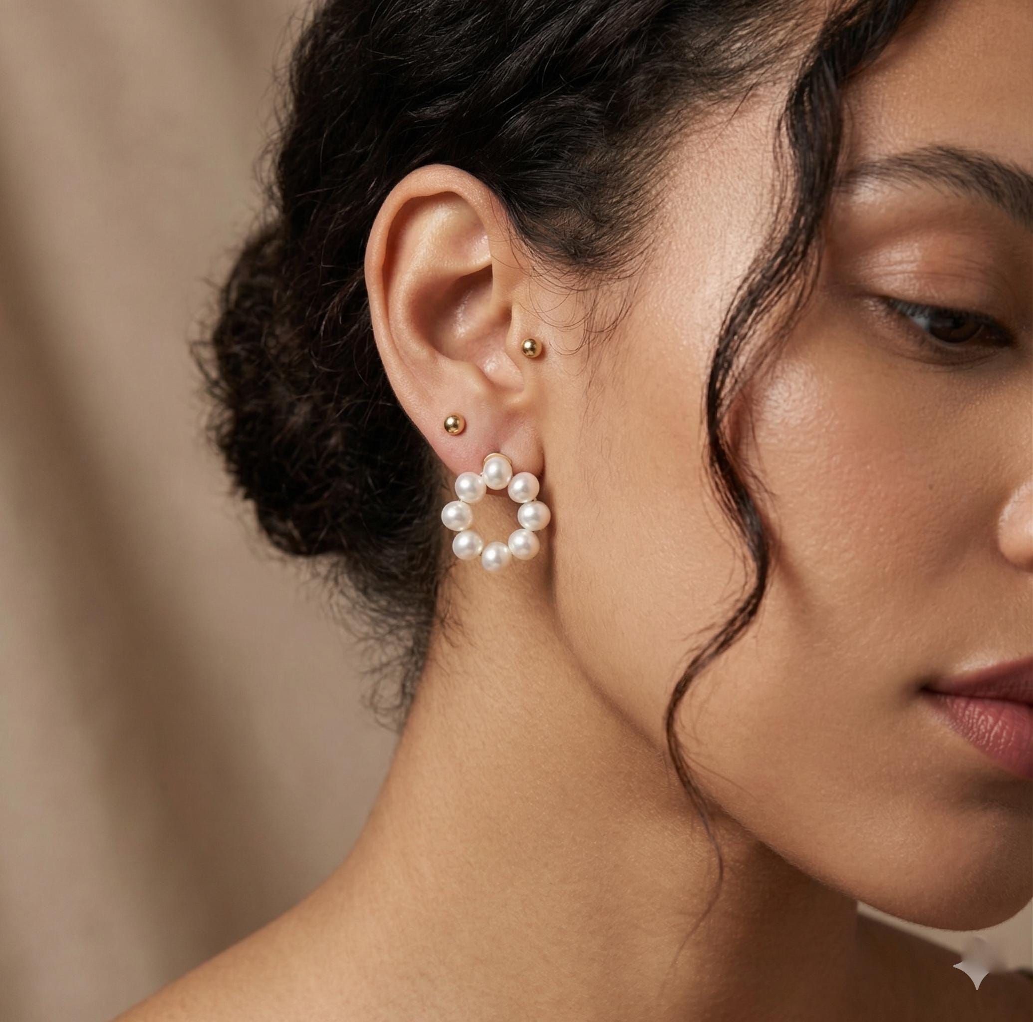 Freshwater pearl cluster stud earrings worn on ear, showing the circular wreath shape and everyday scale