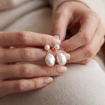 Pearl earrings listing image - Editorial hands shot