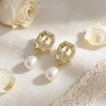 Gold rose pearl drop earrings styled with cream petals and lace