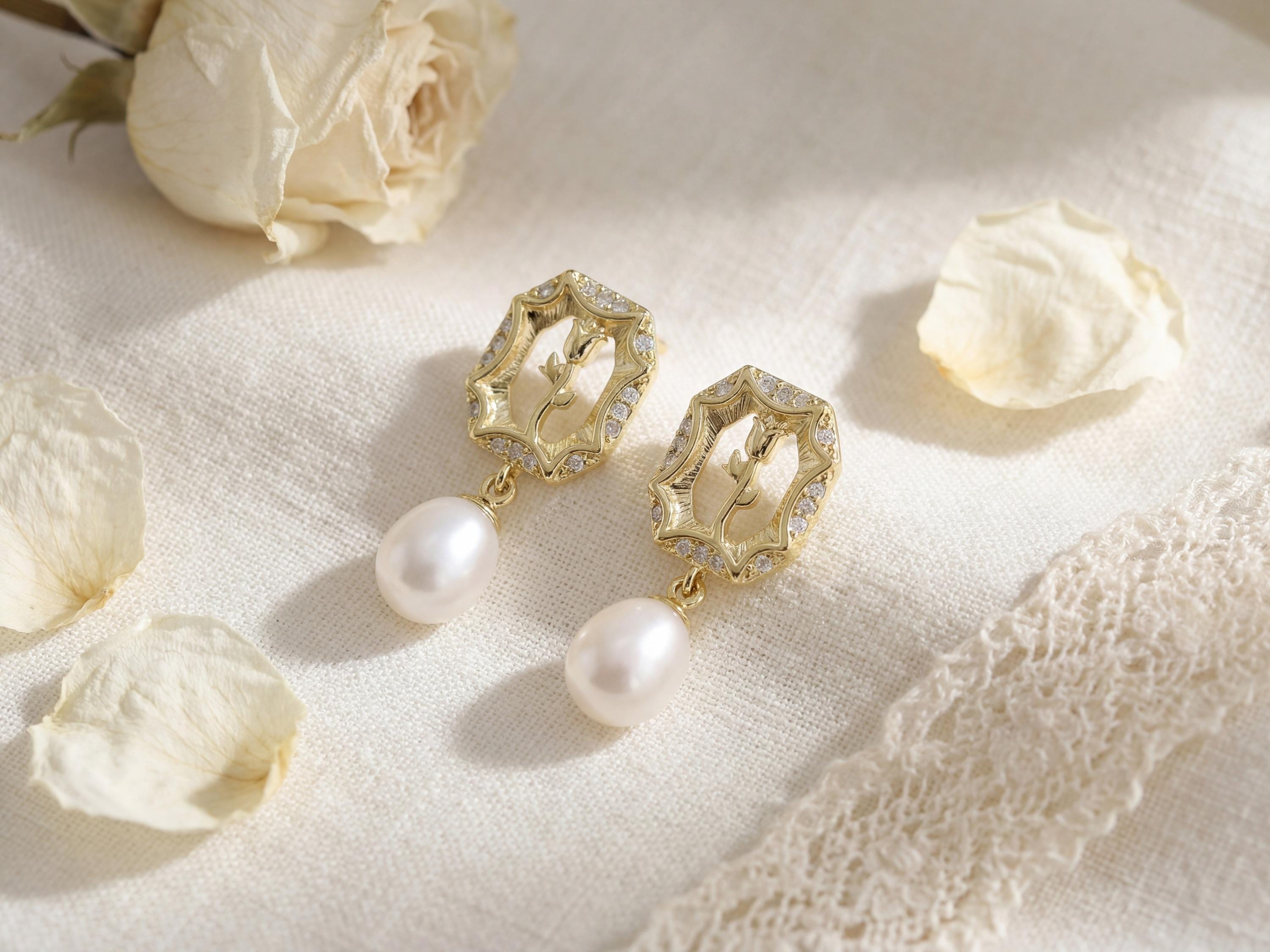 Gold rose pearl drop earrings styled with cream petals and lace