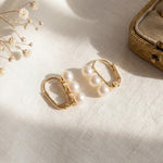 Pair of gold leverback earrings with AAA freshwater pearls in natural light