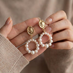 Pearl earrings listing image - Editorial hands shot