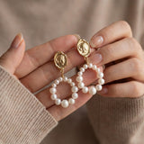 Pearl earrings listing image - Editorial hands shot