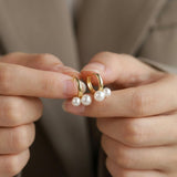 Pearl earrings listing image - Editorial hands shot