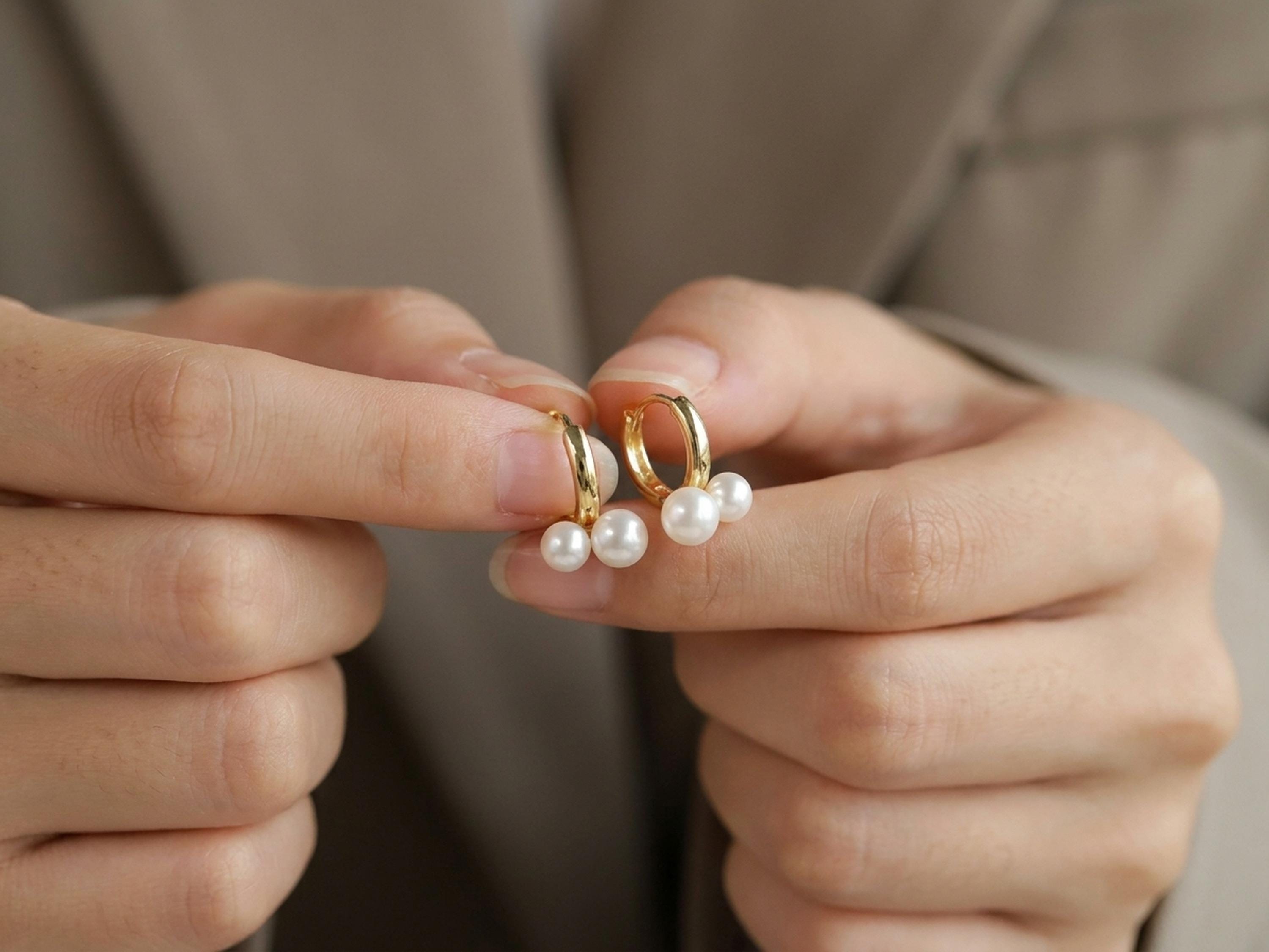 Pearl earrings listing image - Editorial hands shot