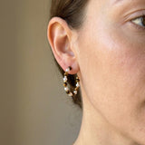 Tiger eye pearl hoop earrings worn on ear with brown gemstone beads, white pearls, and gold tone accents