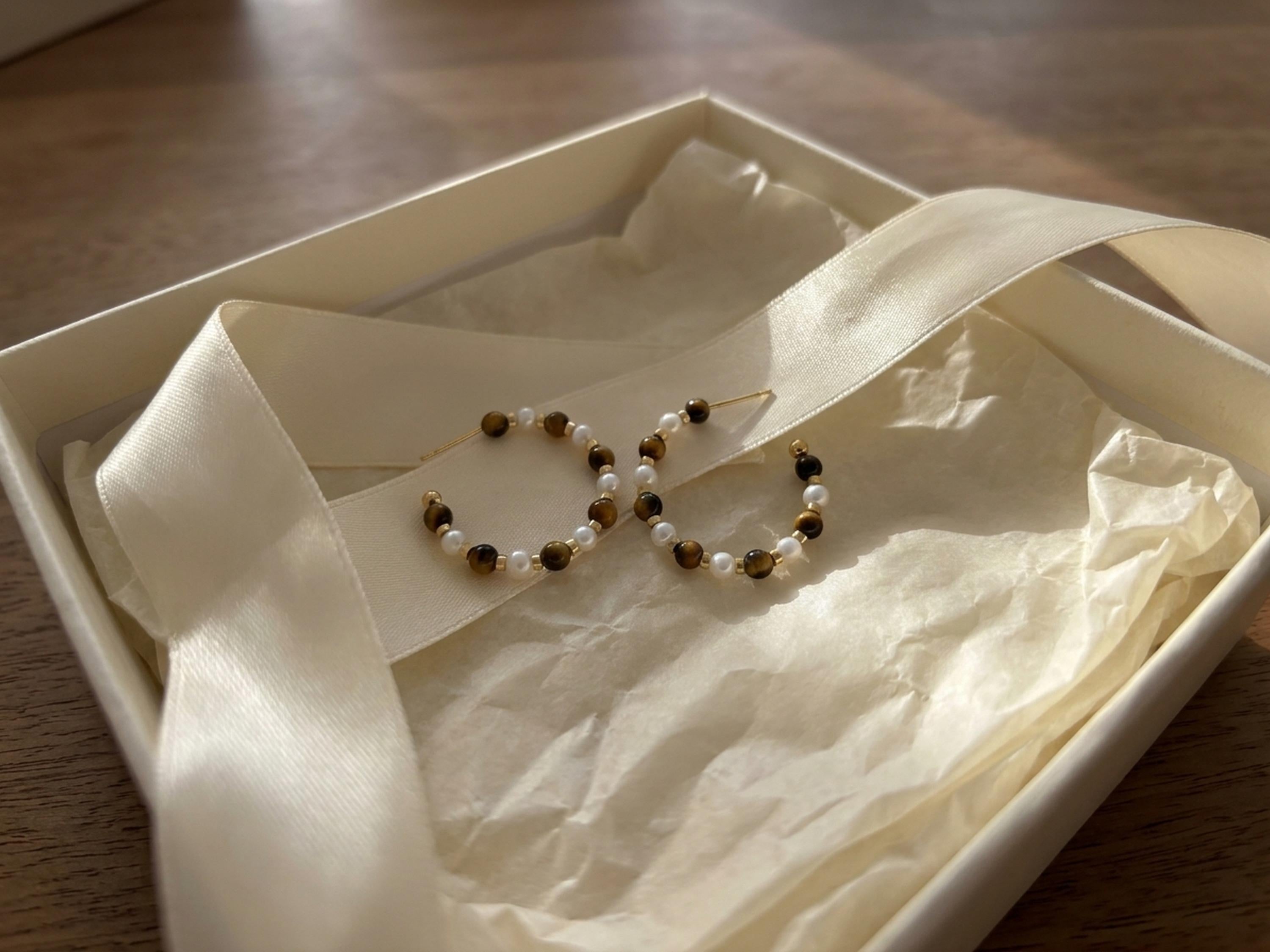 Tiger eye pearl hoop earrings presented in a gift box with ribbon
