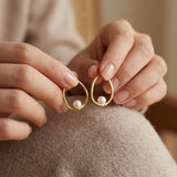 Pearl earrings listing image - Editorial hands shot