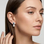 Model wearing vintage blue cubic zirconia pearl earrings with minimalist makeup