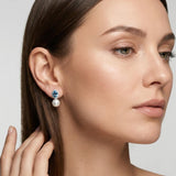 Model wearing vintage blue cubic zirconia pearl earrings with minimalist makeup
