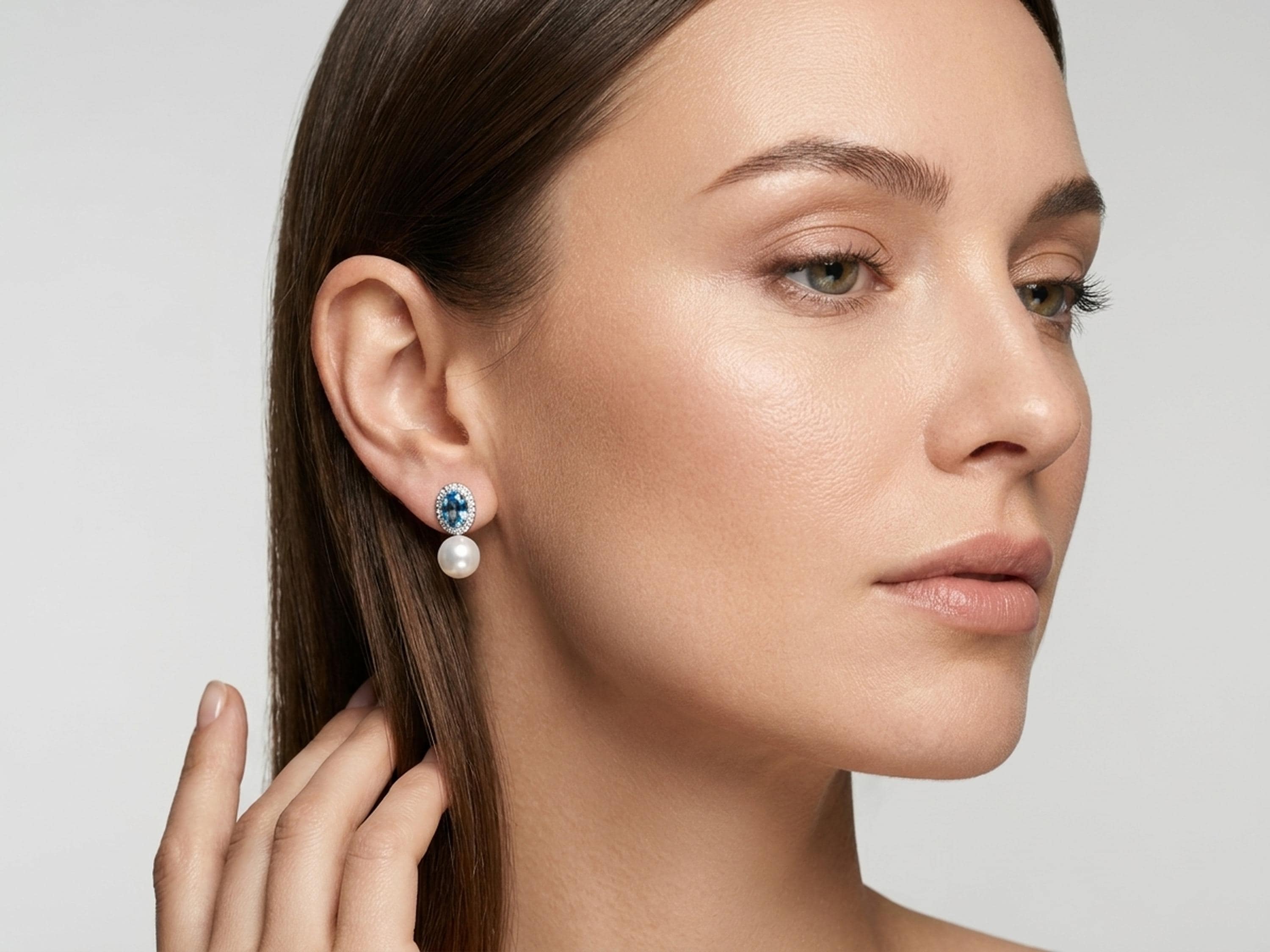 Model wearing vintage blue cubic zirconia pearl earrings with minimalist makeup