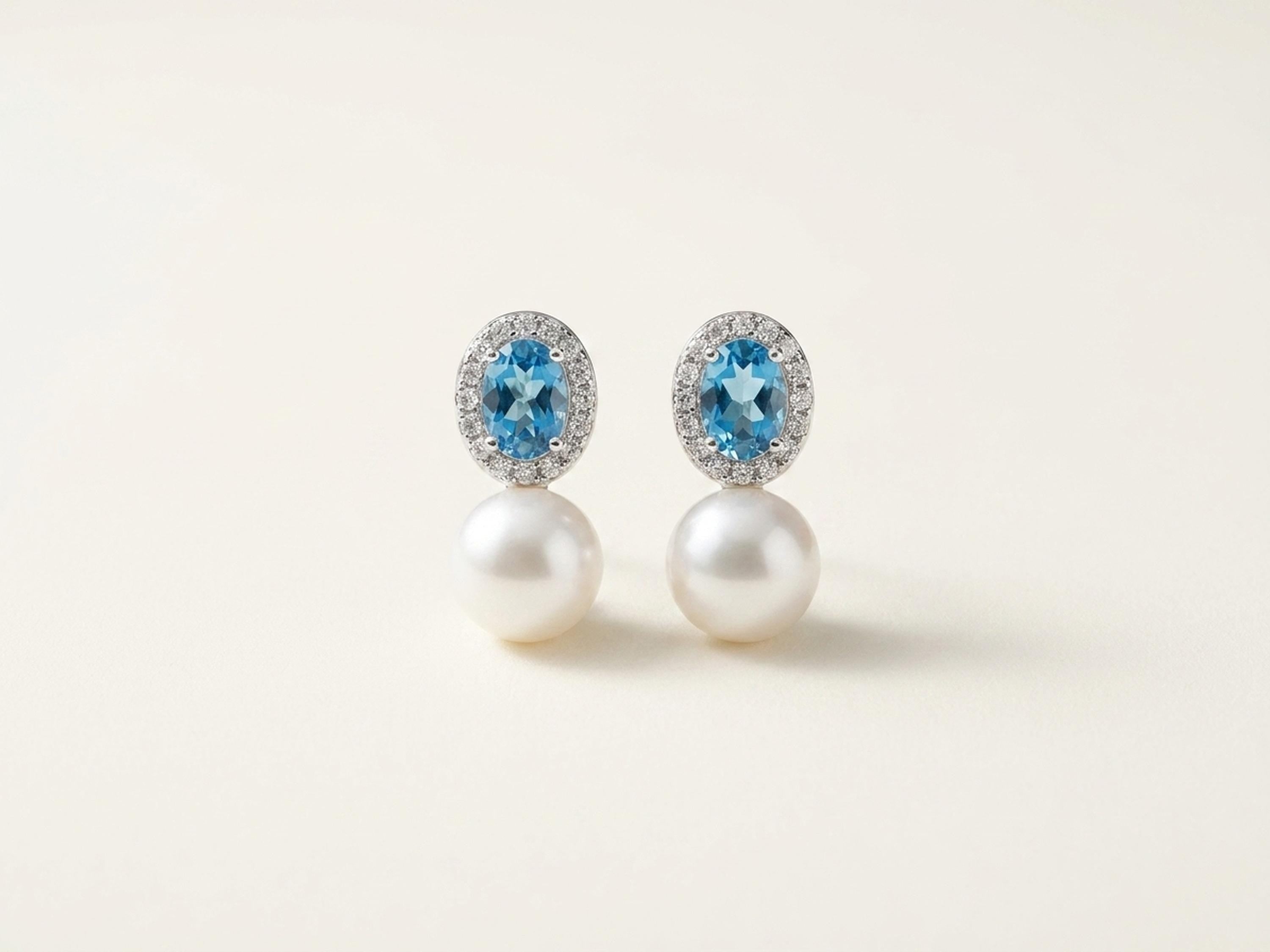Front view of matching blue cubic zirconia and white pearl drop stud earrings