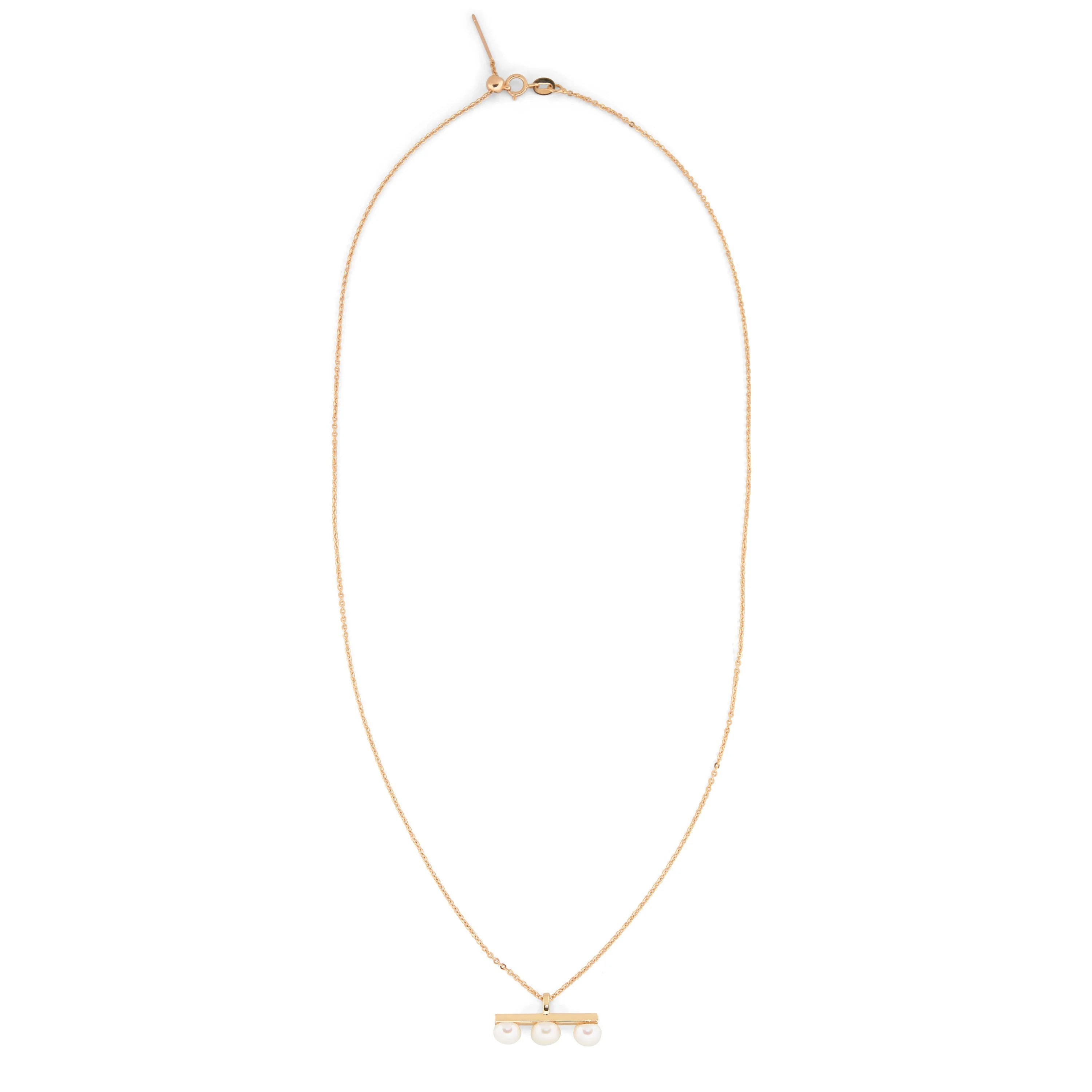 Gold-plated necklace with a bar pendant featuring three pearls.