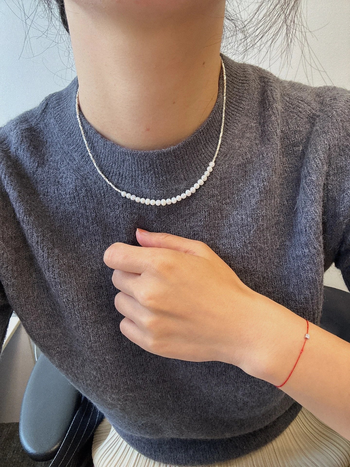 Small around bead pearl necklace with white freshwater pearls.