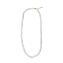 A white freshwater pearl necklace with a gold-colored clasp and extender.