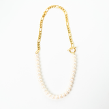 A freshwater pearl necklace with a gold-plated figaro chain and toggle clasp.