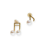 Asymmetrical gold-plated musical note stud earrings with freshwater pearls.