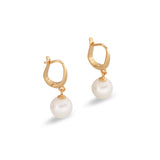 Gold hoop earrings with dangling white pearls.