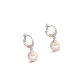 A pair of silver hoop earrings with dangling white pearls.