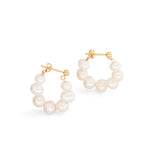 A pair of gold hoop earrings with multiple white pearls.