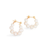 A pair of gold hoop earrings with multiple white pearls.