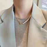 A freshwater pearl necklace with a gold-plated chain and toggle clasp.
