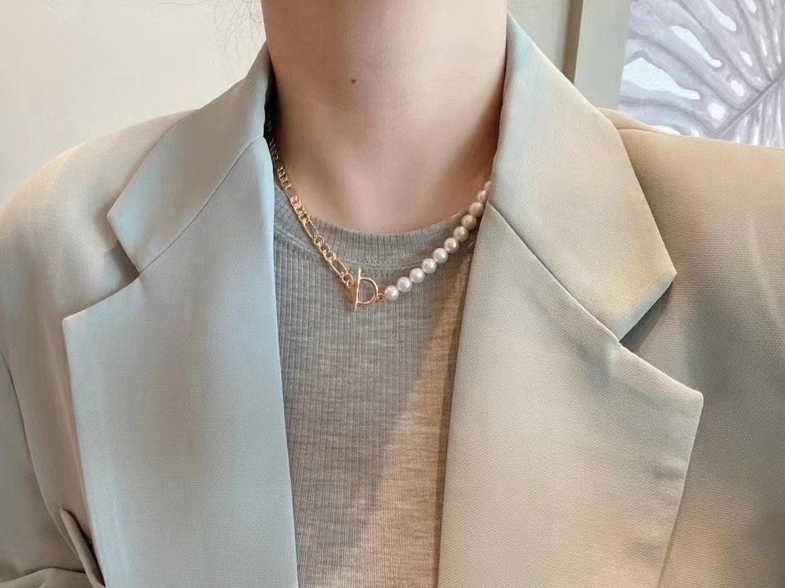 A freshwater pearl necklace with a gold-plated chain and toggle clasp.