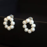 Freshwater pearl flower stud earrings with a circular arrangement of pearls.