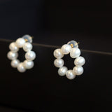 Freshwater pearl flower stud earrings with a circular arrangement of pearls.