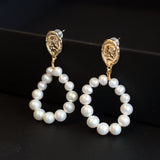 Gold-plated freshwater pearl hoop earrings with a vintage-inspired coin stud.