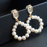 Gold-plated freshwater pearl hoop earrings with a vintage-inspired coin stud.