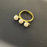 Gold-toned ring with three freshwater pearls arranged in a line.